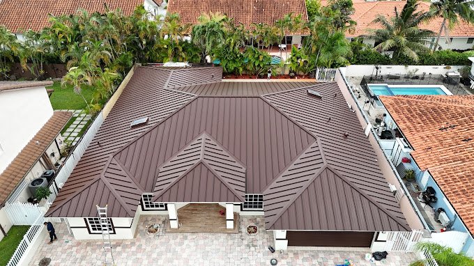 Expert roofing contractors installing a durable metal roof on a Miami home